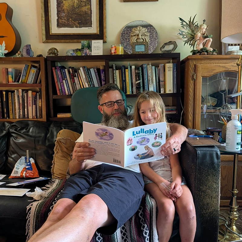 Father and daughter enjoying Lullaby: A Bedtime Story by Scott Randall Lindberg